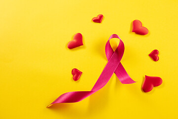 Image showing the text world cancer day and a pink ribbon on a table background