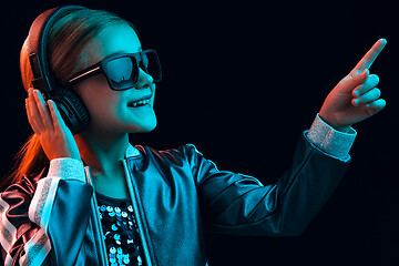 Image showing Young girl with headphones enjoying music