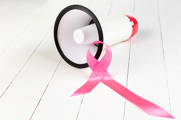 Image showing the text world cancer day and a pink ribbon on a table background