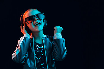 Image showing Young girl with headphones enjoying music