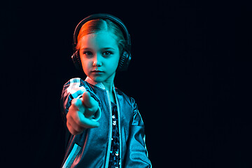 Image showing Young girl with headphones enjoying music