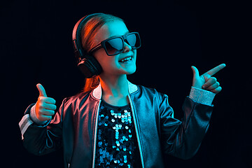 Image showing Young girl with headphones enjoying music