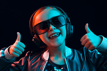 Image showing Young girl with headphones enjoying music