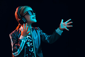 Image showing Young girl with headphones enjoying music