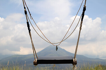 Image showing Wooden swing on the rope with view of Batur volcano 