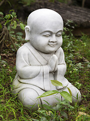 Image showing Small Buddha statue in a garden
