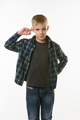 Image showing boy put his index finger to the temple on a white background