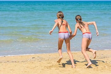 Image showing Children with a run run swimming in the sea