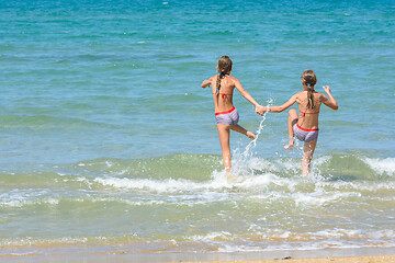 Image showing Children fun and funny run swimming in the sea, left empty place for insertion