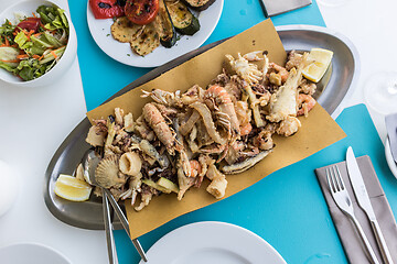 Image showing Delicious fried sea food plate for two on summer vacation in traditional croatian costal restorant by the sea.