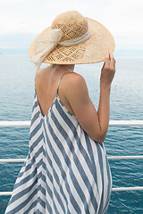 Image showing Beautiful, romantic blonde woman taking selfie self portrait photo on summer vacations traveling by cruse ship ferry boat.