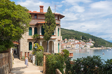 Image showing Female tourist walking along Adriatic sea coast relaxing on vacation in Moscenicka Draga, Istria, Croatia.