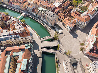 Image showing Aerial drone view of Preseren Squere and Triple Bridge over Ljubljanica river,Tromostovje, Ljubljana, Slovenia. Empty streets during corona virus pandemic social distancing measures