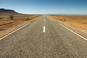 Image showing Asphalt road in a rocky desert