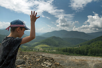 Image showing Boy throwing roks