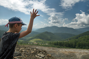 Image showing Boy throwing roks