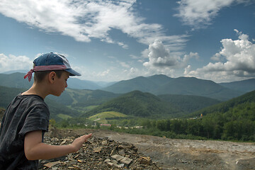 Image showing Boy throwing roks