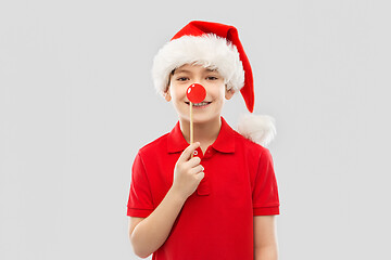 Image showing smiling boy in red t-shirt and santa helper hat