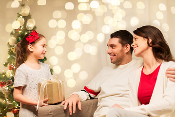 Image showing happy family with christmas present at home