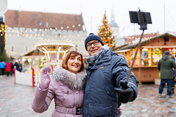 Image showing senior couple taking selfie at christmas market