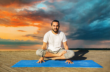 Image showing man making yoga in scale pose outdoors