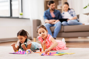 Image showing happy sisters doing arts and crafts at home