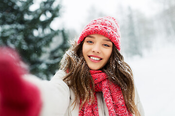 Image showing smiling woman taking selfie outdoors in winter