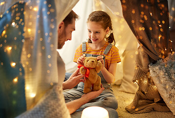 Image showing happy family playing with toy in kids tent at home