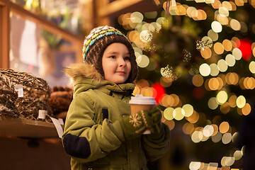 Image showing happy boy with cup of tea at christmas market