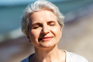 Image showing portrait of senior woman enjoying sun on beach