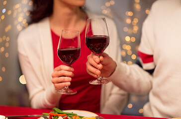 Image showing close up of couple drinking red wine on christmas