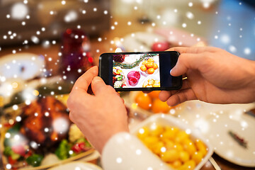 Image showing hands photographing food at christmas dinner