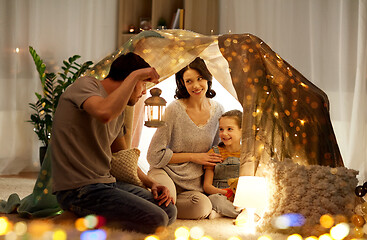 Image showing happy family playing in kids tent at night at home