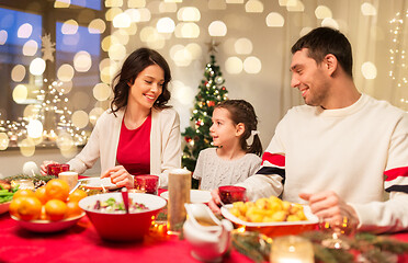 Image showing happy family having christmas dinner at home