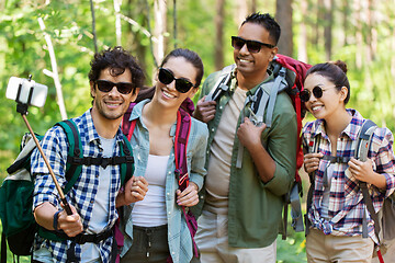 Image showing friends with backpacks hiking and taking selfie