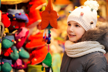 Image showing happy little girl at christmas market in winter