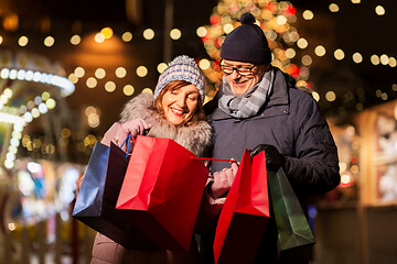 Image showing old couple at christmas market with shopping bags