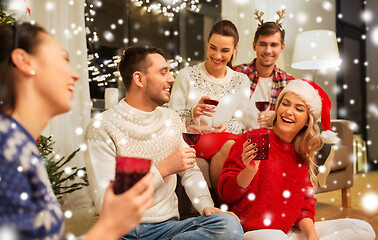 Image showing friends celebrating christmas and drinking wine