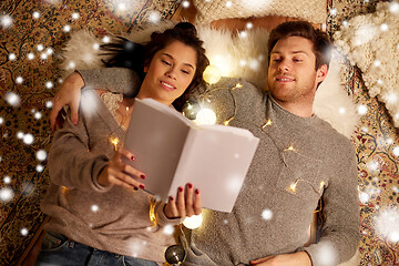 Image showing happy couple reading book at home