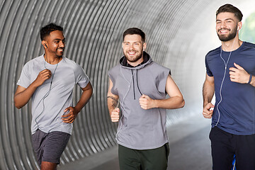 Image showing male friends with earphones running outdoors