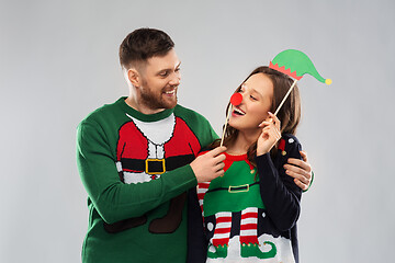 Image showing couple with christmas party props in ugly sweaters