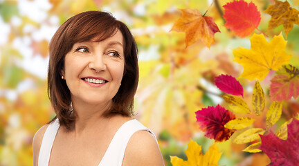 Image showing portrait of happy senior woman over autumn leaves