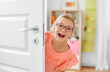Image showing happy smiling beautiful girl behind door at home