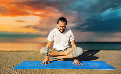 Image showing man making yoga in scale pose outdoors