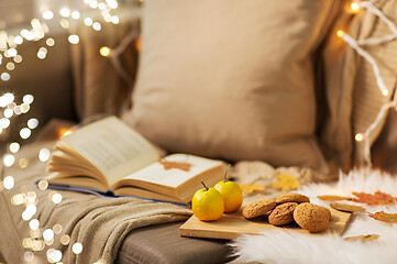 Image showing lemons, book, almond and oatmeal cookies on sofa