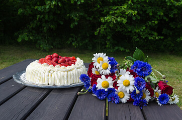 Image showing Bouquet summer flowers and a cream cake