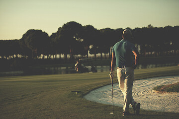 Image showing golfer from back at course looking to hole in distance