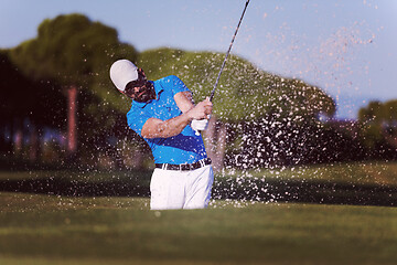 Image showing pro golfer hitting a sand bunker shot