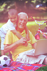 Image showing grandfather and child using laptop