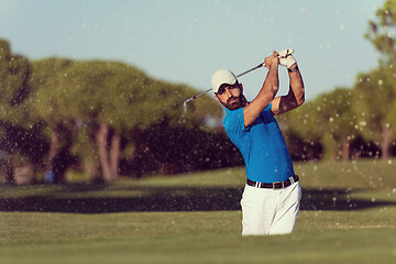 Image showing pro golfer hitting a sand bunker shot